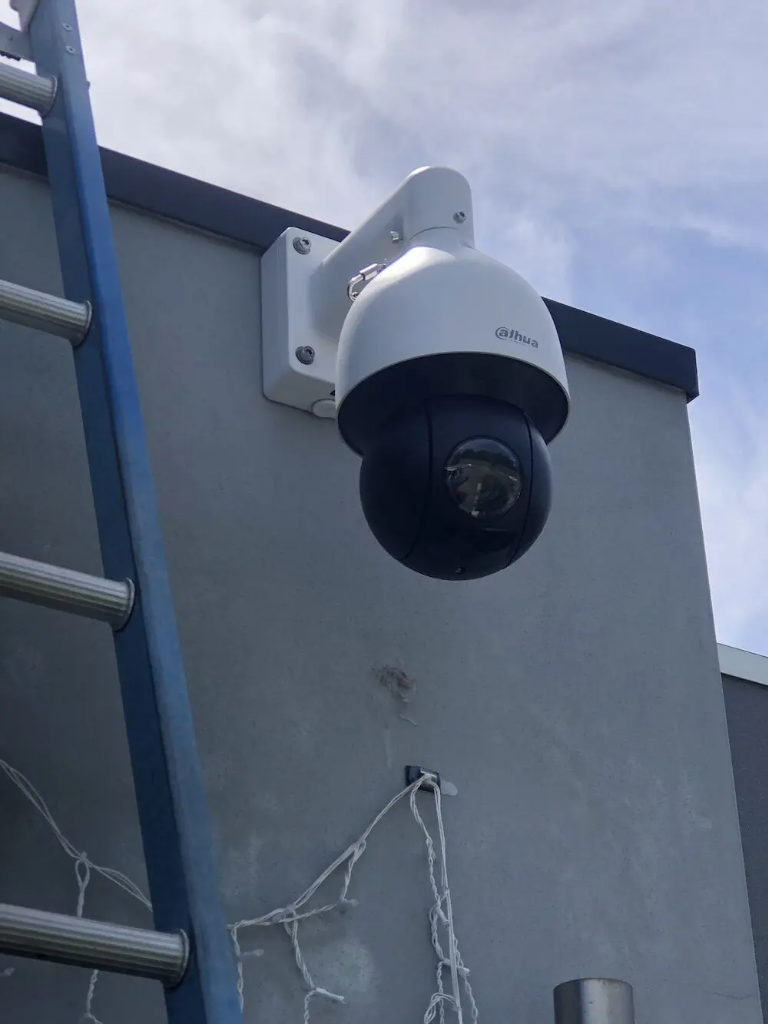 Dahua PTZ security camera mounted on wall bracket with concealed weatherproof cabling